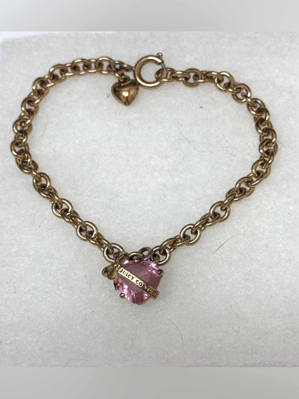 Juicy Couture Heart Wish Bracelet featuring a gold-tone chain and a pink crystal